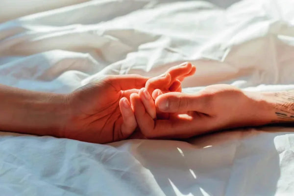 Couple holding each other tightly in bed